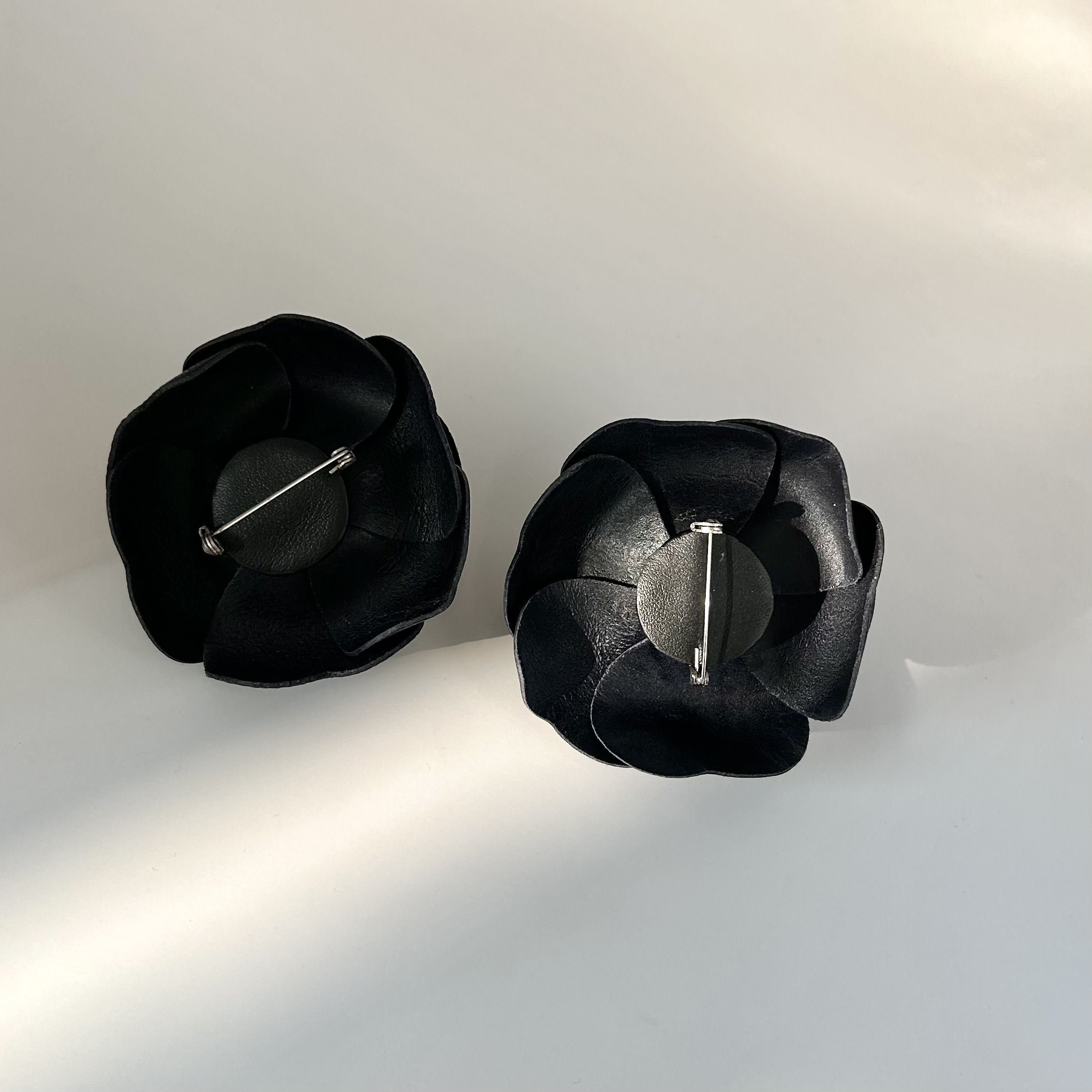 CHANEL dark navy leather Camellia brooch